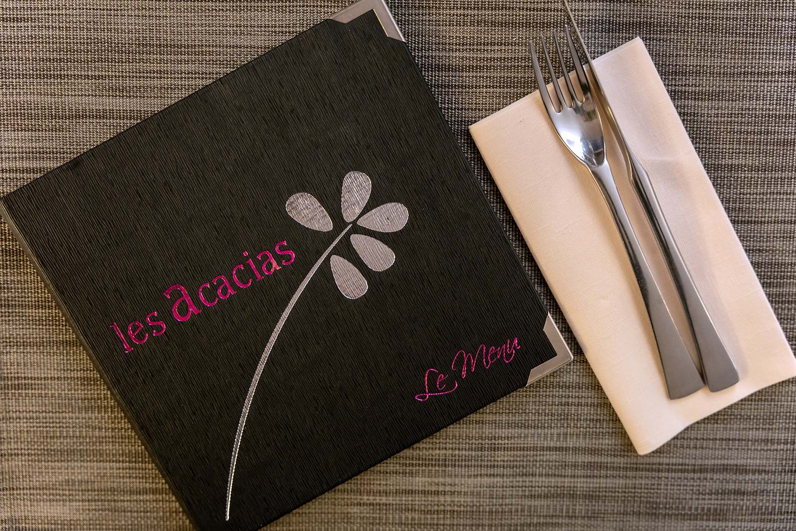 Menu, napkin and cutlery on a table in a gastronomic restaurant near Saintes